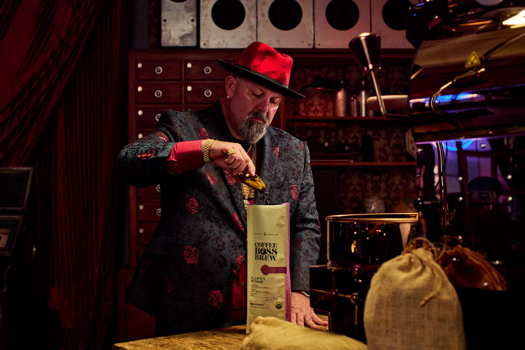 Alex Furioso, founder of Coffee Boss Brew, scooping fresh whole beans